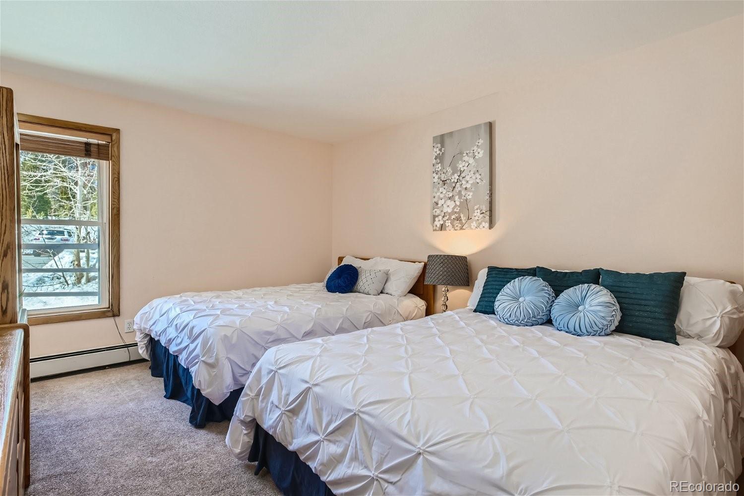 89100 Ryan Gulch Road, Unit 206 Silverthorne, CO 80498 - Photo 6 of 17 a bedroom with two beds and a window
