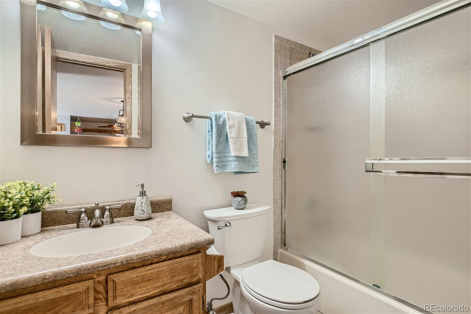 89100 Ryan Gulch Road, Unit 206 Silverthorne, CO 80498 - Photo 8 of 17 a bathroom with a sink vanity mirror and toilet