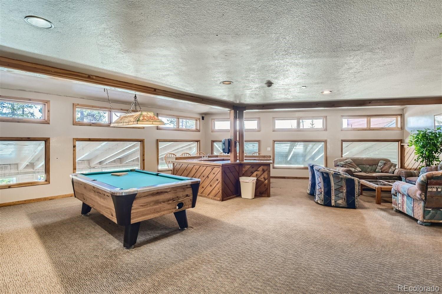 89100 Ryan Gulch Road, Unit 206 Silverthorne, CO 80498 - Photo 9 of 17 a living room with furniture and flat screen tv