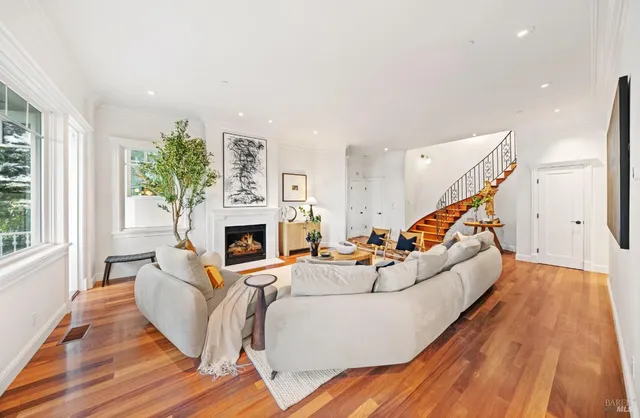 a living room with furniture and a chandelier