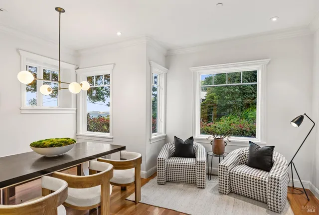 a view of a dining room with furniture window and wooden floor