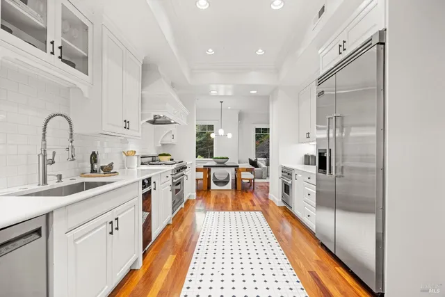 a kitchen with a stove oven and sink