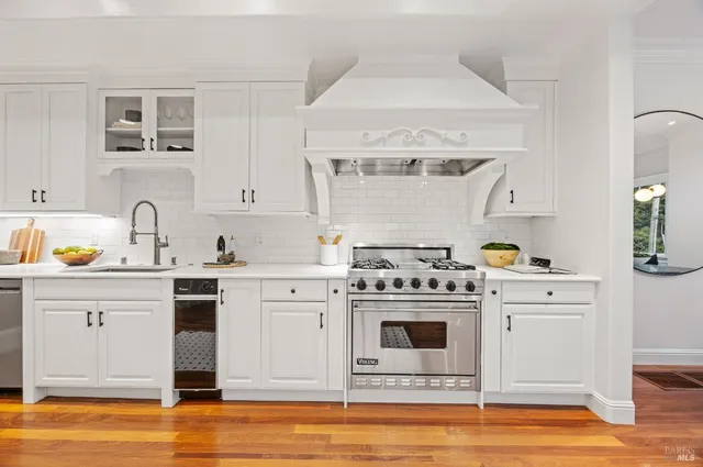 a large kitchen with stainless steel appliances granite countertop a stove and a refrigerator