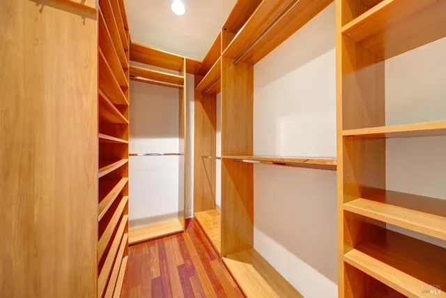 a bedroom with bed and a lamp with wooden floor