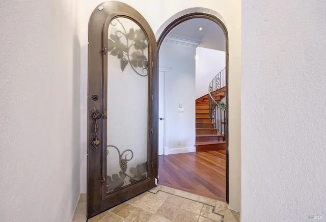 a bathroom with a sink a mirror and painting on the wall