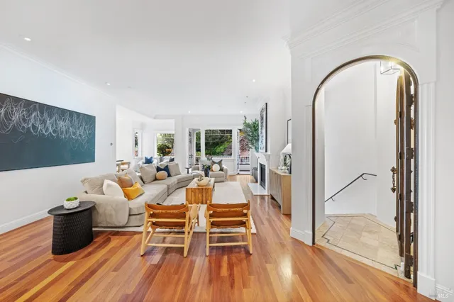 a living room with fireplace furniture and a wooden floor