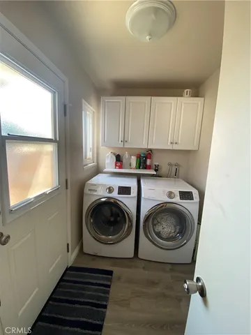 a utility room with sink dryer and washer