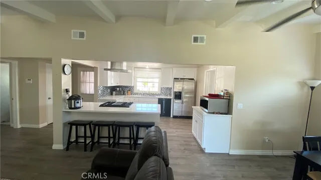a kitchen with a table chairs refrigerator and cabinets