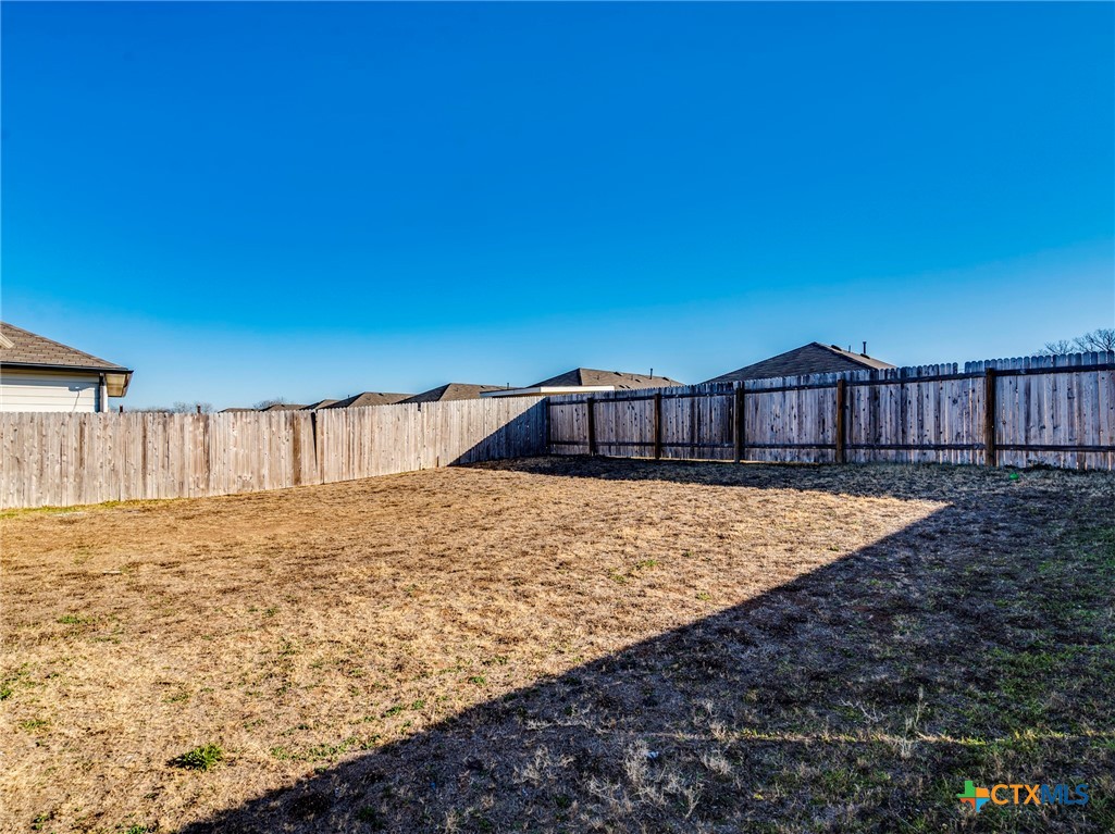 316 Addison Place Lockhart, TX 78644 - Photo 28 of 28 a view of a house with backyard and wooden fence