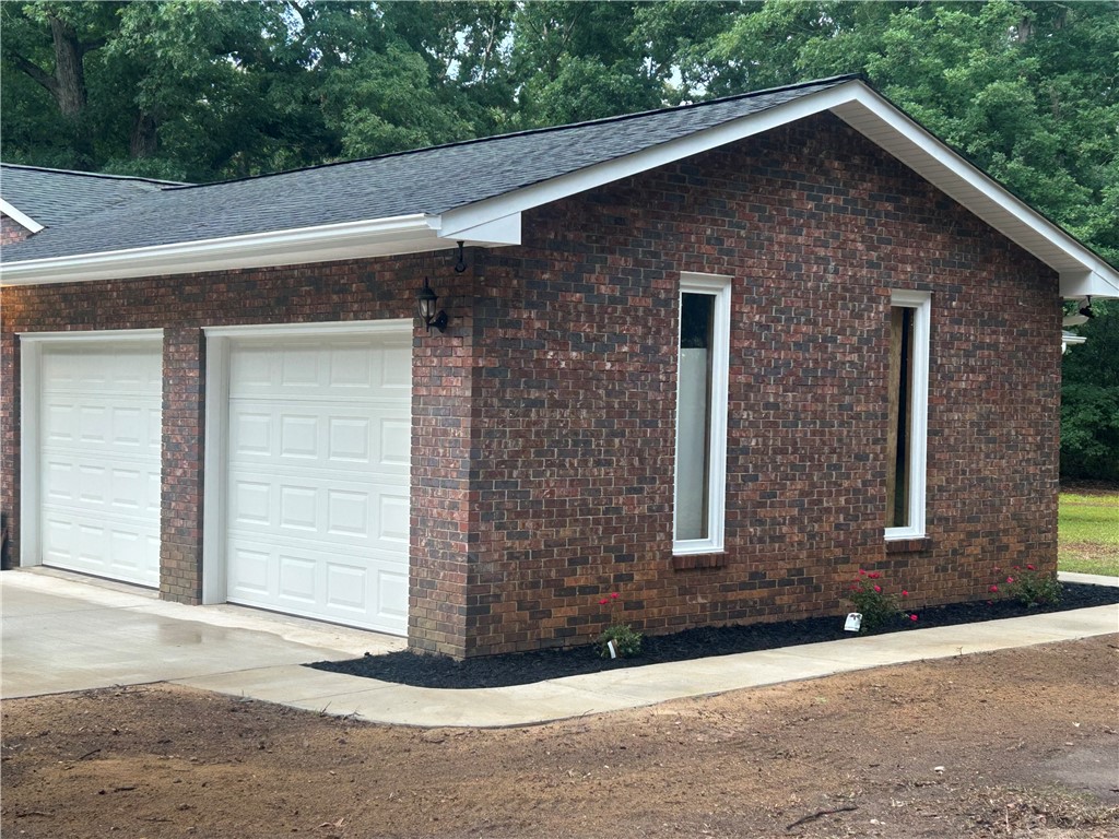 809 Paige Road Honea Path, SC 29654 - Photo 2 of 27 Two convenient garage doors complement the home's sturdy brick construction.