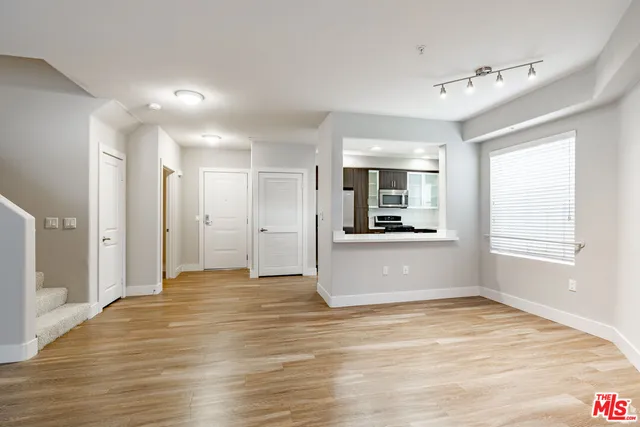 a view of a kitchen with a sink and a window