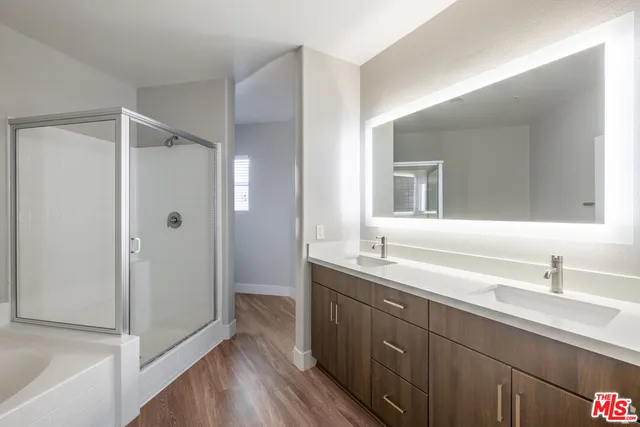 a bathroom with a double vanity sink mirror and