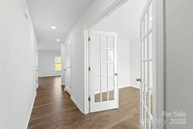 a view of a hallway with wooden floor