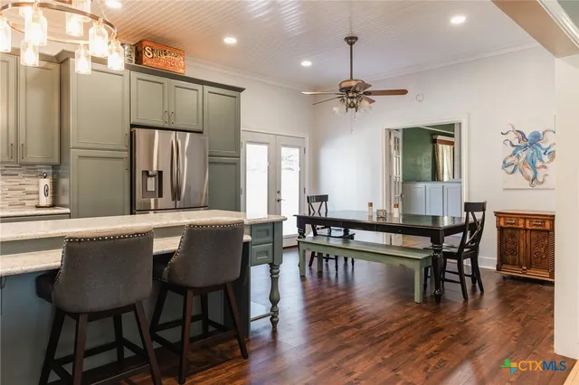 a view of a a dining room with furniture window and wooden floor