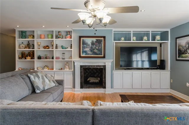 a living room with furniture and a fireplace