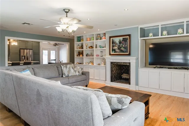 a spacious bedroom with a bed and a flat screen tv