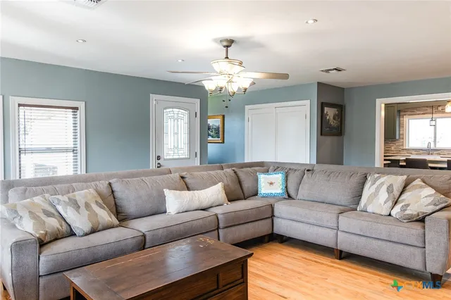 a living room with furniture and a chandelier