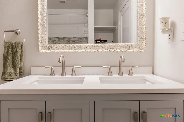 a bathroom with a sink and a mirror