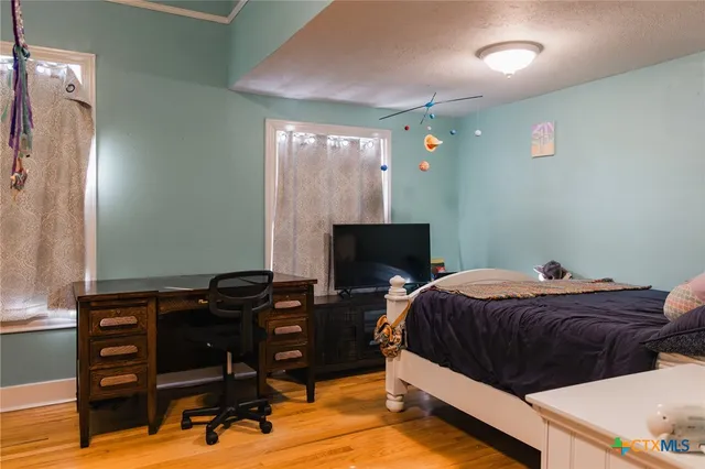 a bedroom with a bed and dresser