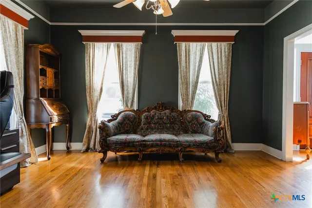 a living room with furniture and a wooden floor