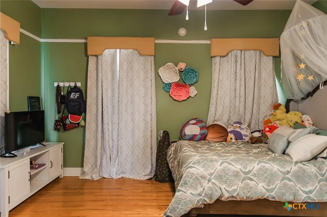 a bedroom with a bed and flat screen tv