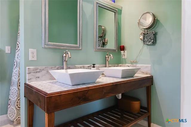 a bathroom with a sink and a mirror