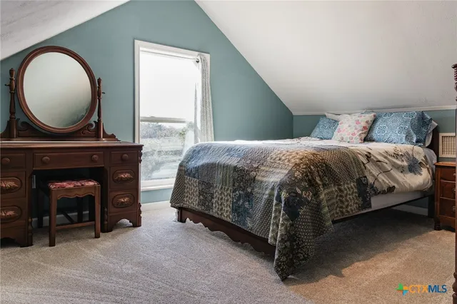 a bedroom with a bed and a fireplace