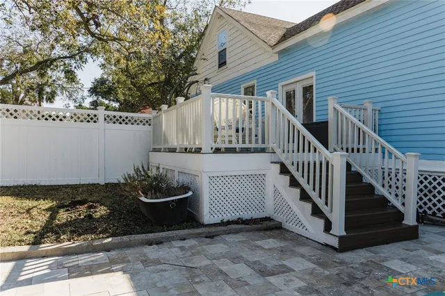 a view of a house with backyard and deck