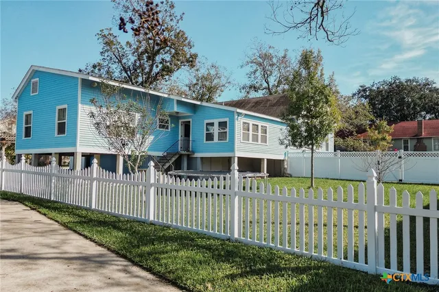 a house view with a garden and deck