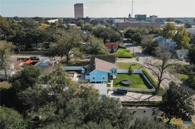 an aerial view of a house with a yard