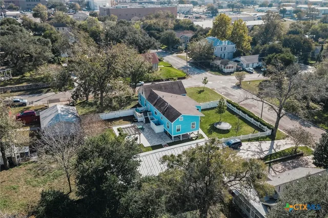 an aerial view of a house with a yard