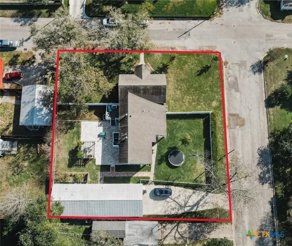 an aerial view of a house with a yard
