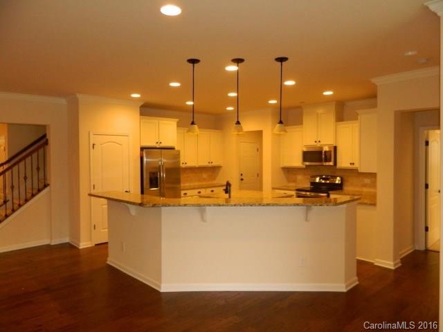 5202 Waterloo Drive, Unit CC174 Tega Cay, SC 29708 - Photo 11 of 15 a large kitchen with stainless steel appliances a large counter top a stove a sink and a refrigerator