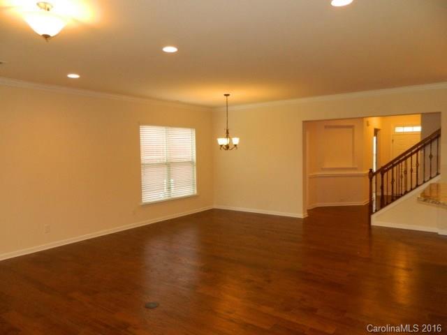 5202 Waterloo Drive, Unit CC174 Tega Cay, SC 29708 - Photo 12 of 15 a view of an empty room with wooden floor and a window