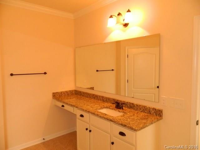 5202 Waterloo Drive, Unit CC174 Tega Cay, SC 29708 - Photo 15 of 15 a bathroom with a granite countertop sink and a mirror