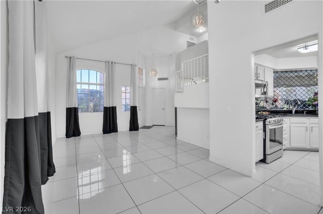 6429 Winding Ridge Las Vegas, NV 89156 - Photo 12 of 22 The open-concept living area flows seamlessly into the kitchen, creating an ideal space for entertaining.