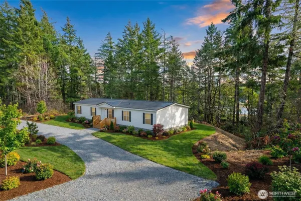 an aerial view of a house with yard and green space