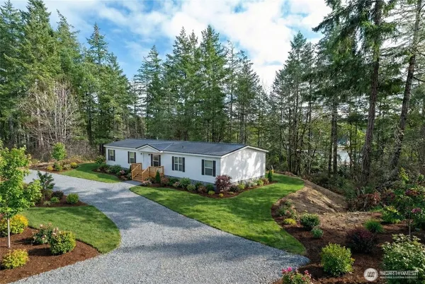 an aerial view of a house with yard and green space