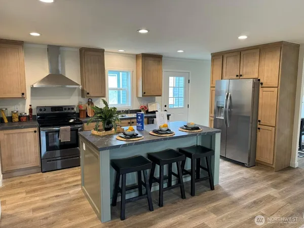 a kitchen with sink stove and refrigerator