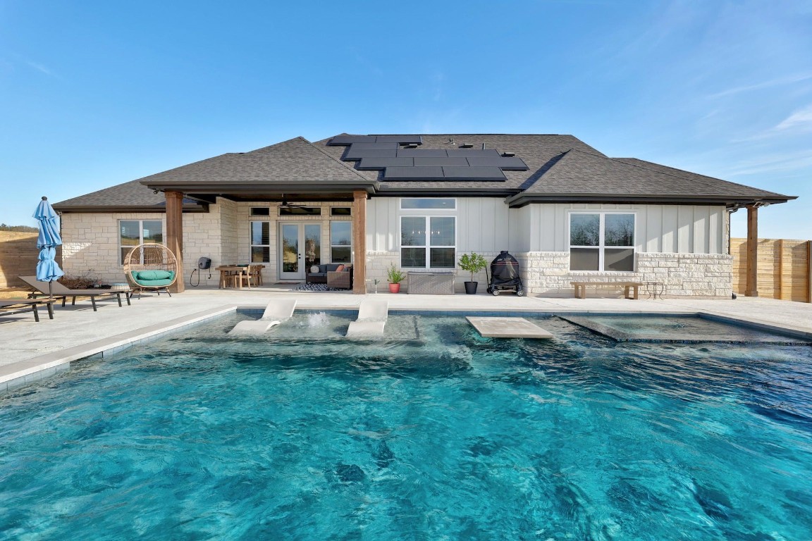 a view of a house with a backyard and a patio