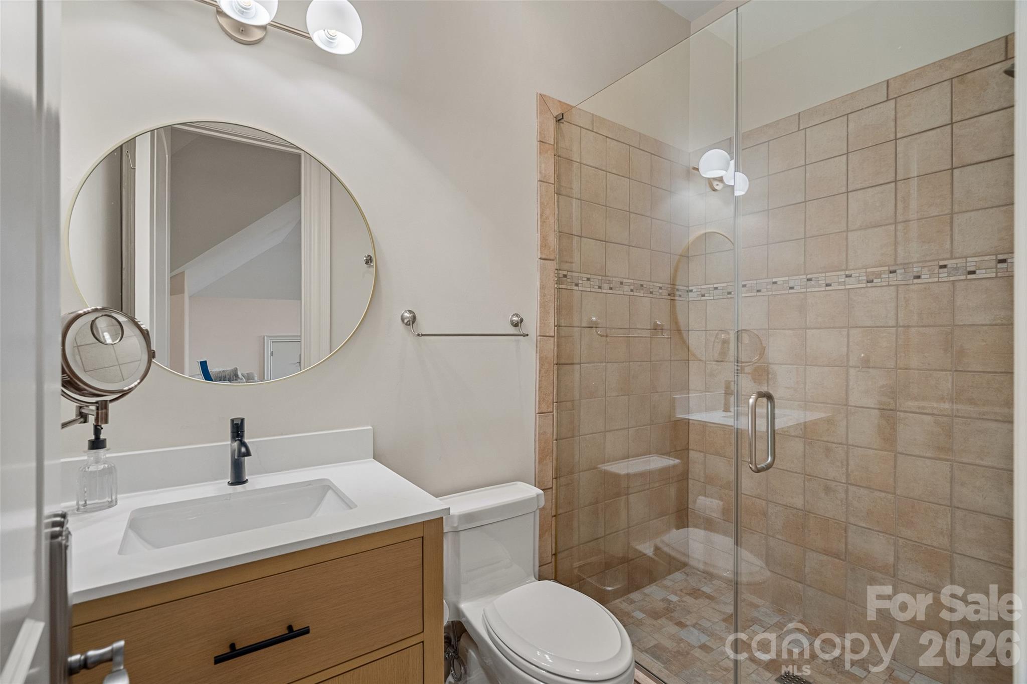 461 Kemp Road Mooresville, NC 28117 - Photo 28 of 48 a bathroom with a sink a toilet and a mirror