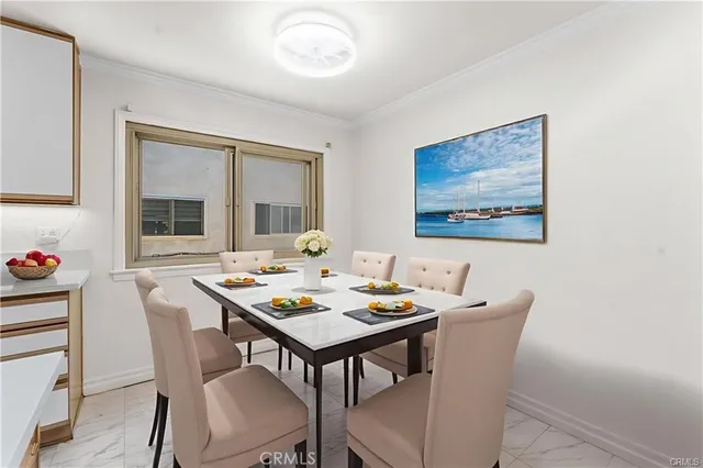 a view of a dining room with furniture and window