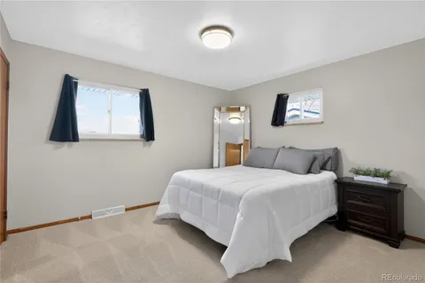 a bedroom with a bed and a wall painting