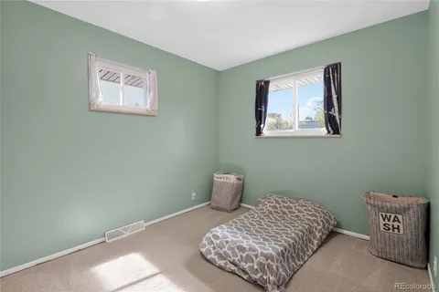 a bedroom with a bed and a painting on the wall