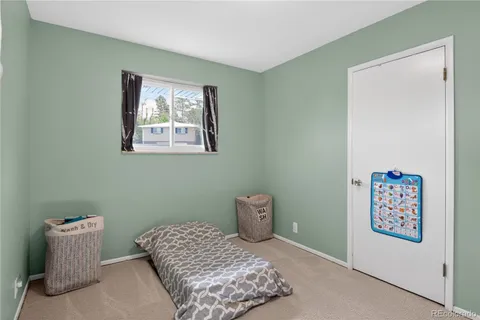 a bedroom with a bed and a wall painting