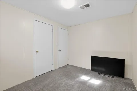 a view of an empty room with a fireplace