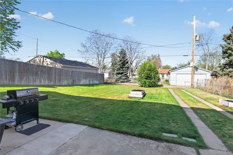 a view of a backyard with swimming pool