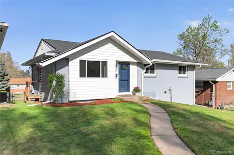 a front view of house with a yard and trees