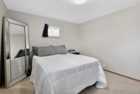 a bedroom with a bed and a night stand