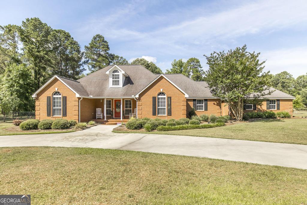712 Flanders Lane Dublin, GA 31021 - Photo 1 of 1 a front view of a house with a yard and garage
